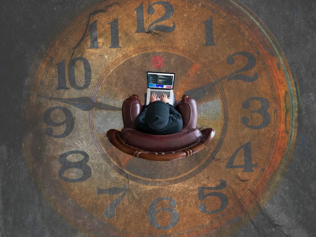 A person working on computer is next to a clock, showing database time savings.